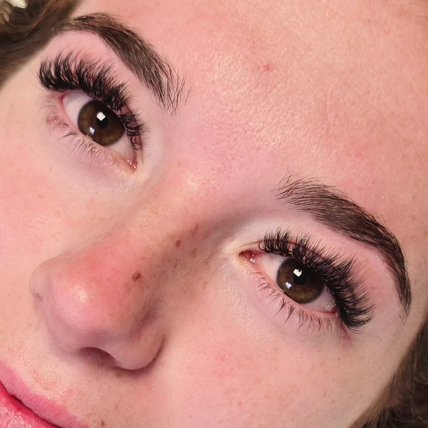Full, dark lash extensions on brown eyes