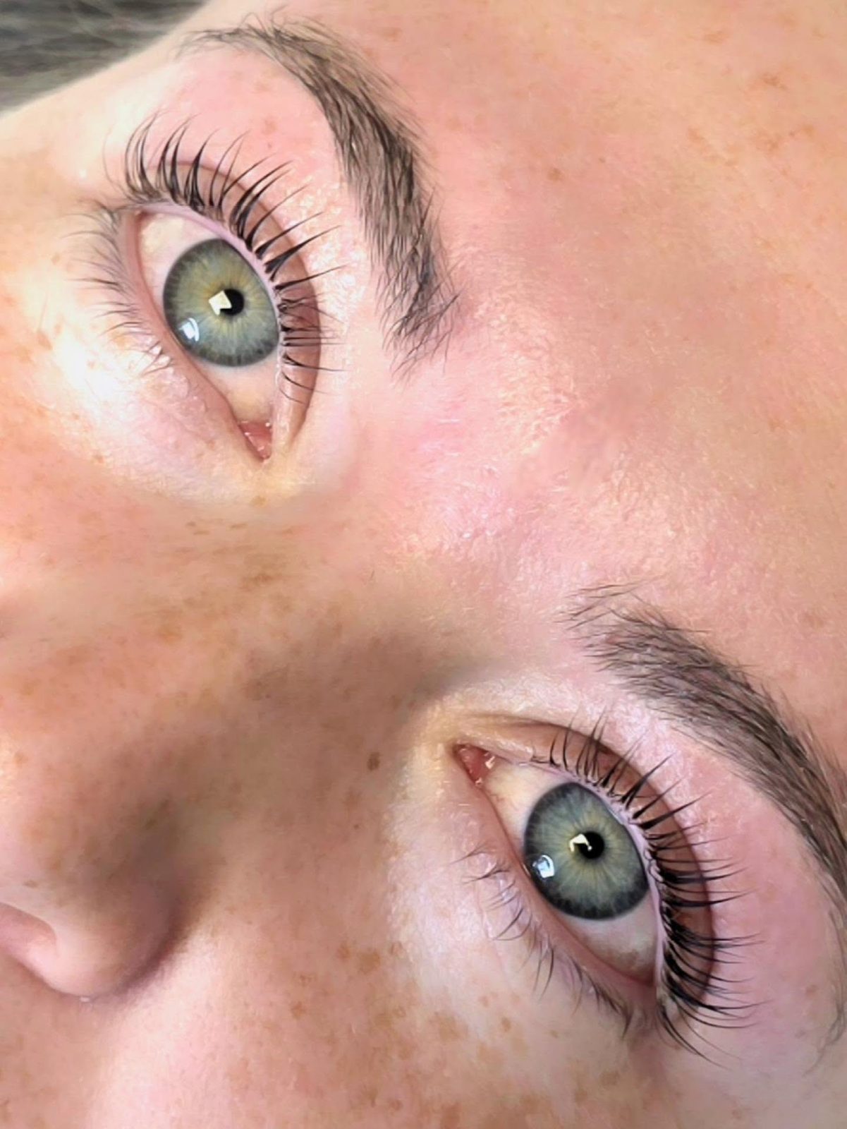 Lifted, tinted lashes on green eyes