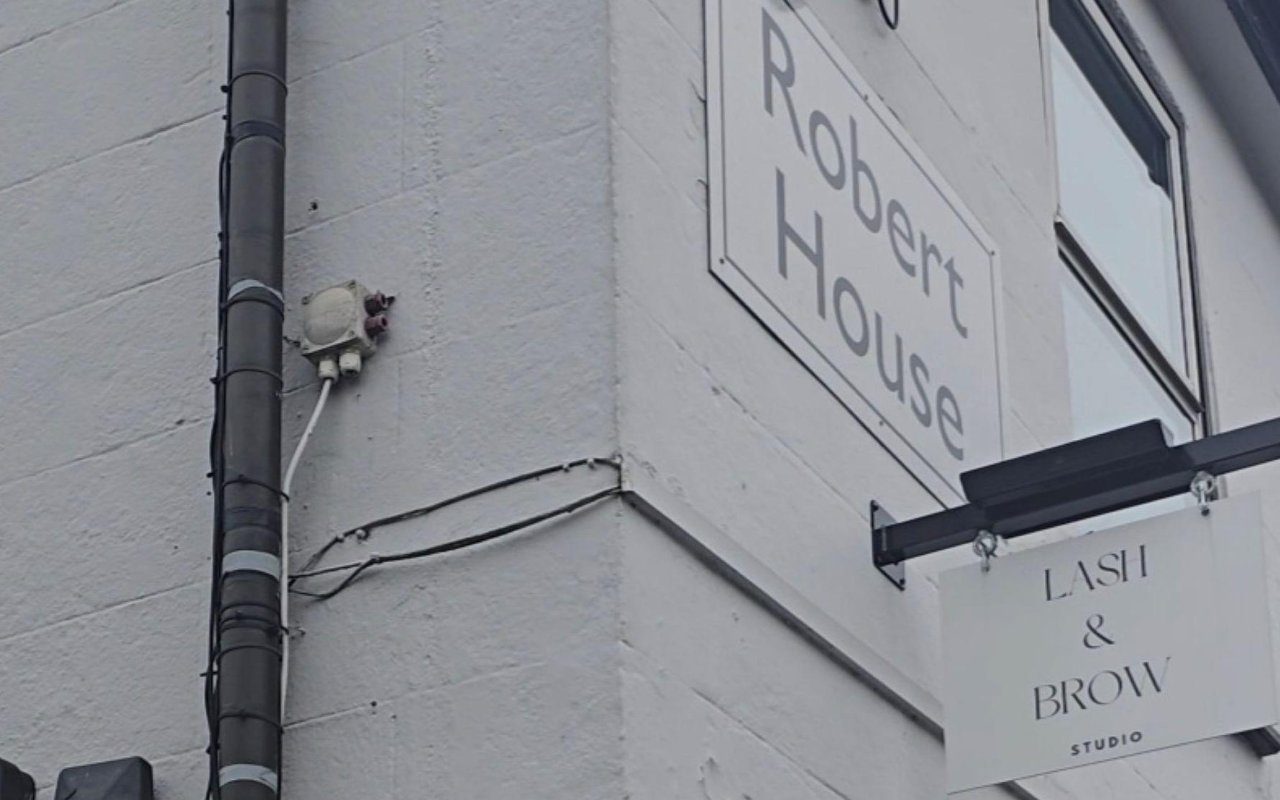 Robert House sign and the hanging Lash & Brow Studio sign